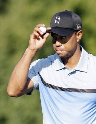 Tiger Woods reacts after making par on the 10th hole in the first round of the PGA Golf Herren Championship at Oak Hill Country Club in Rochester, New York on August 8, 2013.  NYP20130808124