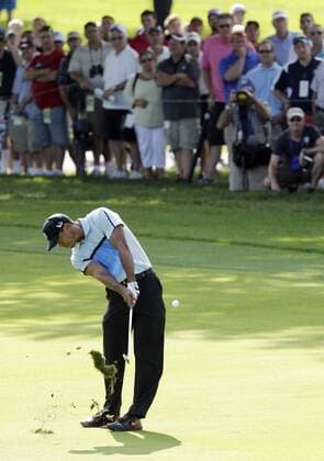 Tiger Woods hits his approach shot to the 13th green in the first round of the PGA Golf Herren Championship at Oak Hill Country Club in Rochester, New York on August 8, 2013.  NYP20130808127