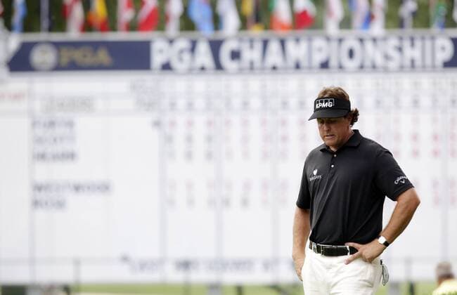 Phil Mickelson reacts on the 18th green before making double bogey on the 18th hole in the first round of the PGA Golf Herren Championship at Oak Hill Country Club in Rochester, New York on August 8, 2013.  NYP20130808179