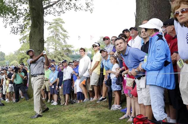 Fans watch Vijay Singh hit out of the rough on the 9th hole in the first round of the PGA Golf Herren Championship at Oak Hill Country Club in Rochester, New York on August 8, 2013.  NYP20130808183