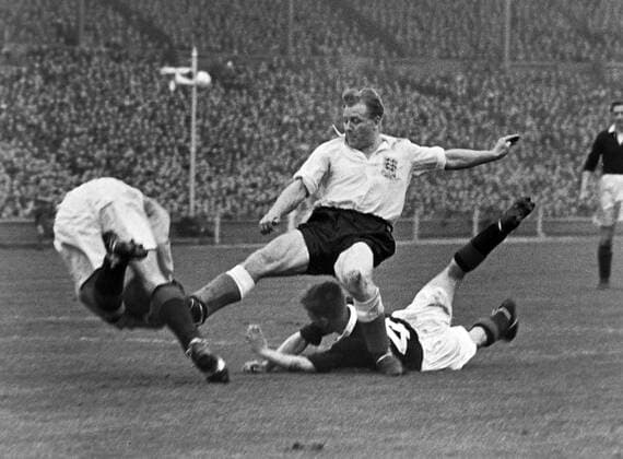 Football - 1954 1955 British Home Championship - England 7 Scotland 2 Scotland goalkeeper Fred Martin makes a save at the feet of England s Frank Blunstone, with Scotland defender John McMillan grounded at Wembley. 02 04 1955 