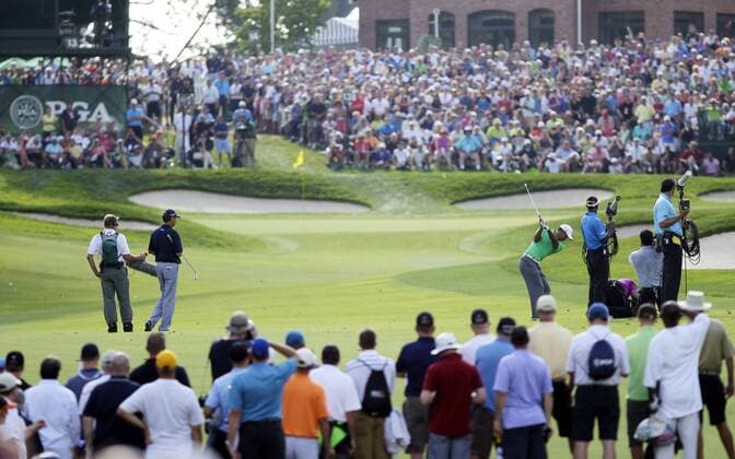 Tiger Woods hits his approach shot to the 13th green in the second round of the PGA Golf Herren Championship at Oak Hill Country Club in Rochester, New York on August 9, 2013.  NYP20130809156