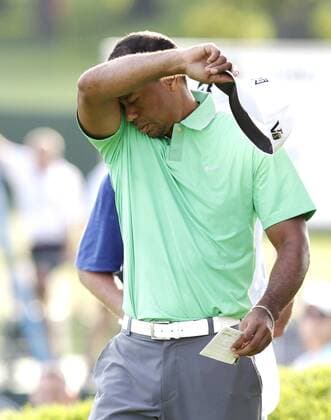 Tiger Woods takes off his hat on the 18th green in the second round of the PGA Golf Herren Championship at Oak Hill Country Club in Rochester, New York on August 9, 2013.  NYP20130809152