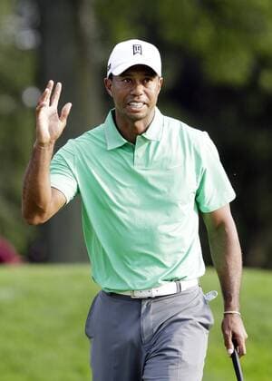 Tiger Woods reacts after making a birdie putt on the 17th hole in the second round of the PGA Golf Herren Championship at Oak Hill Country Club in Rochester, New York on August 9, 2013.  NYP20130809154