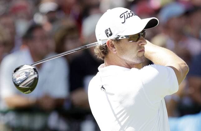 Adam Scott tees off on the 1st hole in the third round of the PGA Golf Herren Championship at Oak Hill Country Club in Rochester, New York on August 10, 2013.  NYP20130810115