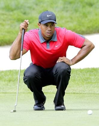 Tiger Woods lines up a putt on the 3rd green in the final round of the PGA Golf Herren Championship at Oak Hill Country Club in Rochester, New York on August 11, 2013.  NYP20130811106