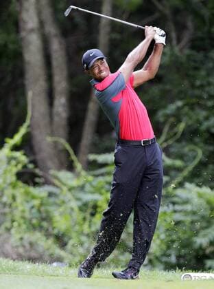 Tiger Woods hits a tee shot on the 3rd hole in the final round of the PGA Golf Herren Championship at Oak Hill Country Club in Rochester, New York on August 11, 2013.  NYP20130811108