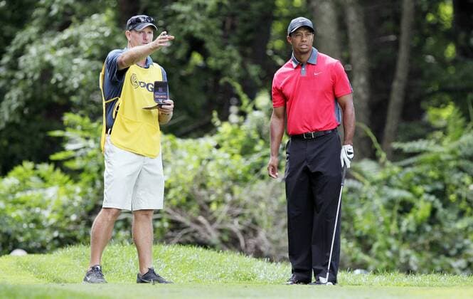 Tiger Woods and Caddie Joe LaCava stand on the 3rd hole tee box in the final round of the PGA Golf Herren Championship at Oak Hill Country Club in Rochester, New York on August 11, 2013.  NYP20130811110