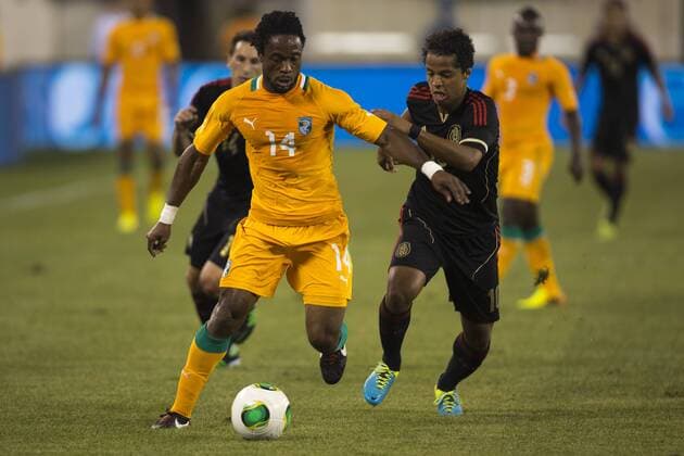 NEW JERSEY, Aug. 14, 2013 (Xinhua) -- Giovani dos Santos (R) of Mexico vies for the ball with Jean-Jacques Gosso (L) of Cote d Ivoire during a friendly match in New Jersey, the United States, Aug. 14, 2013. (Xinhua StraffonImages) (itm) (ce) (SP)US-NEW JERSEY-SOCCER-MEXICO VS COTE D IVOIRE 