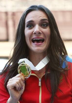 ITAR-TASS: MOSCOW, RUSSIA. AUGUST 15, 2013. Gold medal winner, Russia s Yelena Isinbayeva poses with her medal during the medal ceremony for the women s pole vault final at Luzhniki on Day 6 of the 14th IAAF World Championships in Athletics.  premiumd RE12571E