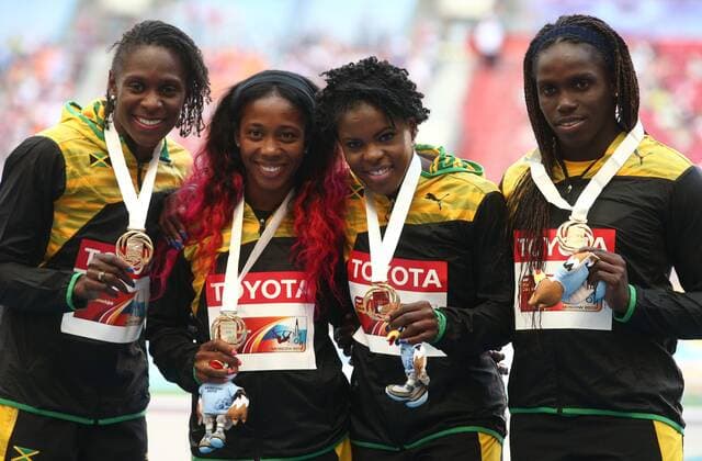ITAR-TASS: MOSCOW, RUSSIA. AUGUST 18, 2013. Jamaica s gold medalists Kerron Stewart, Shelly-Ann Fraser-Pryce, Schilonie Calvert, and Carrie Russell (L-R) pose at the awarding ceremony for the women s 4x100m relay event at the 2013 IAAF World Championships in Athletics, at Luzhniki Stadium.  premiumd RE125C31