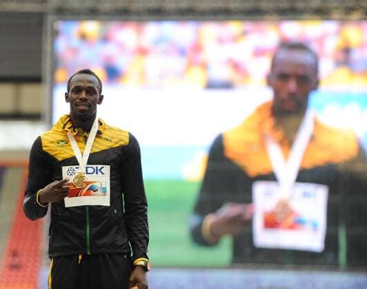 Usain Bolt of Jamaica reacts during the awarding ceremony for men s 200m of the 14th IAAF World Athletics Championships Moscow 2013 at Luzhniki Stadium in Moscow, Russia, on Aug. 18, 2013. Usain Bolt claimed the title with 19.66 seconds. (Xinhua Jia Yuchen) (SP)RUSSIA-MOSCOW-ATHLETICS-IAAF WORLD CHAMPIONSHIPS 