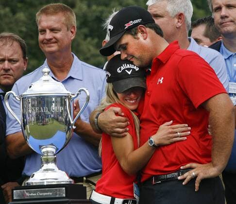 Aug. 18, 2013 - Greensboro, North Carolina, U.S - PATRICK REED and his wife JUSTINE REED hug after receiving the trophy after winning the 2013 Wyndham Championship at Sedgefield Country Club. Golf 2013 - Wyndham Championship  - ZUMAh10
