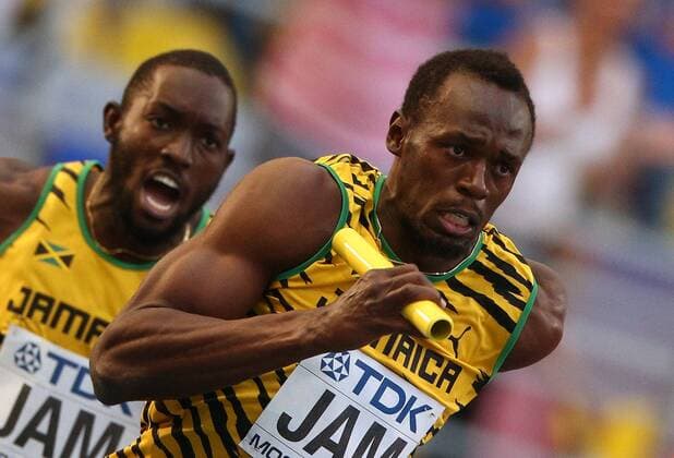 ITAR-TASS: MOSCOW, RUSSIA. AUGUST 18, 2013. Jamaica s Usain Bolt (R) competes to win the men s 4x100m relay final at the 14th IAAF World Championships in Athletics, at Luzhniki Stadium.  premiumd Highlight RE125CB0