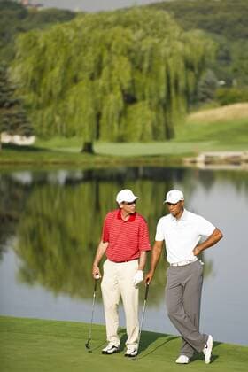 Aug. 21, 2013 - Jersey City, New Jersey, U.S - August 21, 2013: Tiger Woods (USA) talks to his partner in front of a reflection of a tree in the water hazard in the background during The Barclays Fed Ex Pro-Am at Liberty National Golf Course in Jersey City, NJ. Kostas Lymperopoulos csm GOLF 2013: The Barclays Fed Ex Championship AUG 21 - ZUMAc04