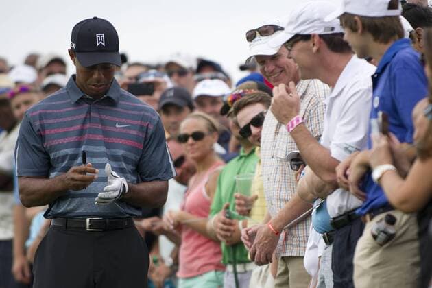 Aug. 23, 2013 - Jersey City, New Jersey, U.S - August 23, 2013: Tiger Woods (USA) removes his glove and autographs it for a smiling fan on the first hole after he asked the gallery to step back during the the second round of The Barclays Fed Ex at Liberty National Golf Course in Jersey City, NJ. Kostas Lymperopoulos csm GOLF 2013: The Barclays Fed Ex Championship Second Round AUG 23 - ZUMAc04