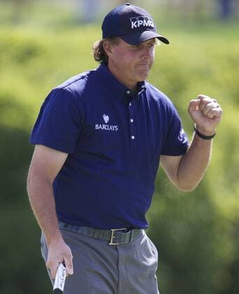 Phil Mickelson of the United States reacts as he made a successful putt on the 10th hole green during the Second Round of the BMW Championship golf tournament at Conway Farms Golf Club in Lake Forest, Illinois, the United States, on Sept, 12, 2013. (Xinhua Ting Shen) (SP)US-LAKE FOREST-GOLF-BWM CHAMPIONSHIP 