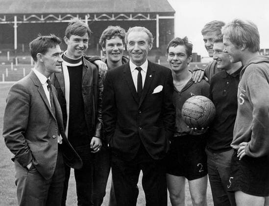 Sir Stanley Matthews talking with players at the Port Vale football ground, after his release from hospital, following a serious road accident two weeks previous. 13th August 1966  UnitedArchives00590577