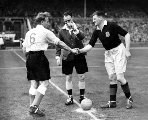 England v Scotland Billy Wright (England captain) on left, shaking hands with G.L Young (Scottish captain) on right, while the referee G. Mitchell (Scotland) looks on. 14th April 1951  UnitedArchives00597089