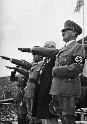 1936 Olympics, Berlin - Adolf Hitler (April 20, 1889 - April 30, 1945) was Chancellor of Germany from 1933, and Führer of Germany from 1934 until his death. He was leader of the National Socialist German Workers Party - the Nazi Party. Photo shows - Saluting the Olympic flag raised for the eleventh Olympics, Berlin 1936 inaugural ceremony (grusst die Olympische Fahne, nachdem er die Spiele der XI Olympiade Berlin 1936 fur eroffnet erklart hat) Â  UnitedArchives00834913