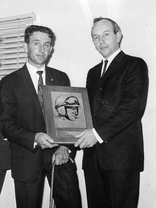 John Surtees (right) the present world champion car racing driver received a special commemorative plaque to mark his 1964 World Champiojship on four wheels from Derek Minter the reigning motor cycle King of Brands 1965  UnitedArchives00925688