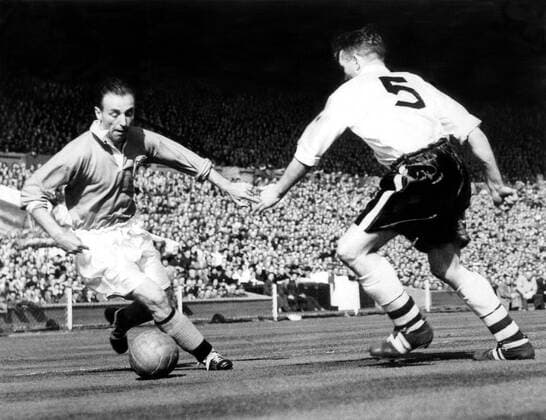 1953 FA Cup Final Bolton Wanderers v Blackpool Stanley Matthews the Blackpool outside right, demonstrates his wizardly skill as he steers the ball past Bolton s Barrass during the FA Cup Final at Wembley. Matthews set this ball up to Bill Perry who scored the fourth and winning goal. 2nd May 1953  UnitedArchives00926038