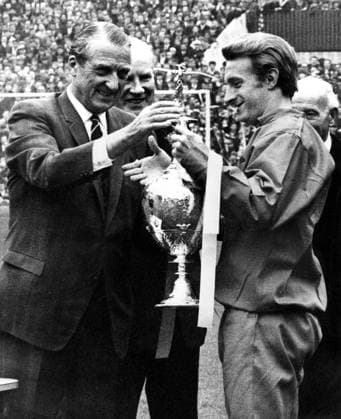Denis Law, Manchester United captain receives the League Championship trophy from Mr L T Shipman, (Football League President) before the First Division match against Stoke City at Old Trafford. 14th May 1967.  UnitedArchives00926656