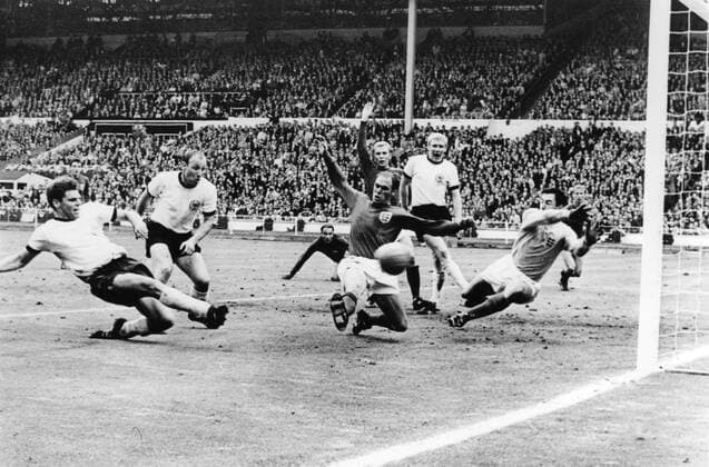 Just a few seconds to go in the World Cup Final and West Gemany s Wolfgang Weber side-foots the ball past England s Gordon Banks, Goalkeeper, to snatch the eualiserat Wembley Stadium July 30th 1966. In the extra time that followed, England scored twice to end up 4-2 winners. Also in this picture are West German captain Uwe Seeler (second left) England s Ramon Wilson (dark shirt); behind Wilson is Moore, the England captain; Schnellinger (white shirt) and in the background extreme right, Jackie Charlton. Just seen in hte background centre, is George Cohen, the other England pull back. 30th July 1966  UnitedArchives01028390