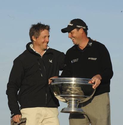 29.09.2013. St Andrews Scotland. The 4th and final Round of the Dunhill Golf Championship, from Old Course St Andrews Hugh Grant and Davie Howell on the Swilken Bridge xLorrainexHillx  ActionPlus20522721
