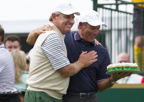 03 October 2013: International Team Captain Nick Price presenting a cake to United States Team Captain Fred Couples for his birthday during the day one of The Presidents Cup at Muirfield Village GC in Dublin, Ohio GOLF: OCT 03 PGA Golf Herren - The Presidents Cup - Day One Icon131003013 EDITORIAL USE ONLY