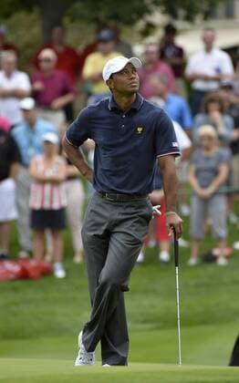 United States Team member Tiger Woods stands on the fifth green during the fourball matches at the 2013 Presidents Cup at Muirfield Village Golf Club in Dublin, Ohio on October 3, 2013.  BKX2013100325