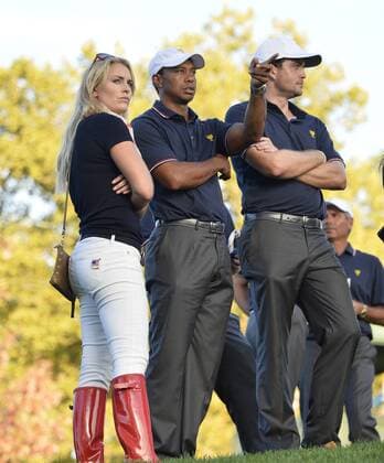 United States Team members Tiger Woods (C) and Keegan Bradley (R) and Lindsey Vonn look up the 17th hole during the fourball matches against the International Team at the 2013 Presidents Cup at Muirfield Village Golf Club in Dublin, Ohio on October 3, 2013. After Thursday s matches, the United States leads 3.5 to 2.5 points.  BKX2013100364