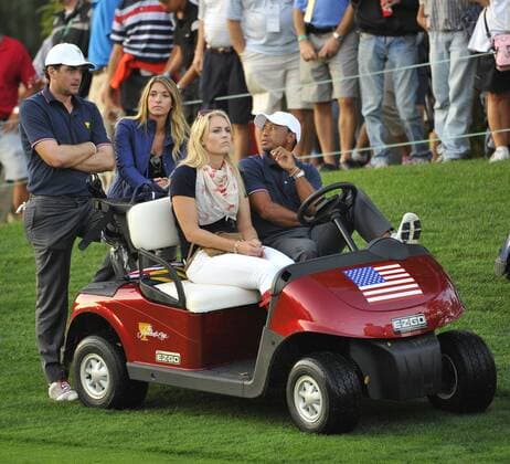 United States Team member Keegan Bradley and girlfriend Jillian Stacey (L) and U.S. Team Member Tiger Woods (R) and girlfriend Lindsey Vonn watch play on the 18th hole during the fourball matches at the 2013 Presidents Cup at Muirfield Village Golf Club in Dublin, Ohio on October 3, 2013. After Thursday s matches, the United States leads 3.5 to 2.5 points.  BKX2013100373