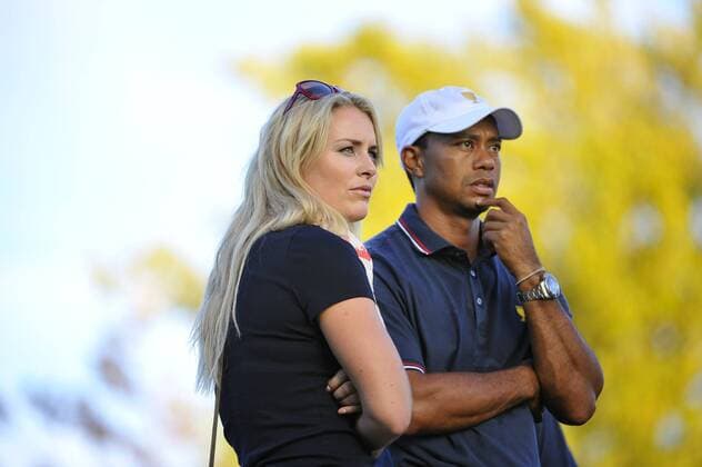 United States Olympic Skier Lindsey Vonn (L) and United States Team member Tiger Woods look up the 17th hole during the fourball matches against the International Team at the 2013 Presidents Cup at Muirfield Village Golf Club in Dublin, Ohio on October 3, 2013. After Thursday s matches, the United States leads 3.5 to 2.5 points.  BKX2013100877