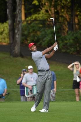 United States Team member Tiger Woods makes his approach short on the ninth hole during the second round foursome competition against the International Team at the 2013 Presidents Cup at Muirfield Village Golf Club in Dublin, Ohio on October 4, 2013.  BKX2013100458
