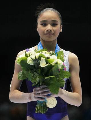 ANTWERP, Oct. 5, 2013 -- Gold medalist Huang Huideng reacts during the awarding ceremony for the woman s uneven bar final of the world gymnastics championships in Antwerp, Belgium, Oct. 5, 2013. 