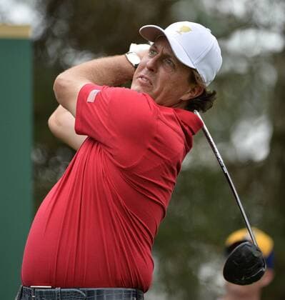 United States Team member Phil Mickelson tees off on the sixth hole during the third round four-ball competition against the International Team at the 2013 Presidents Cup at Muirfield Village Golf Club in Dublin, Ohio on October 5, 2013.  BKX2013100510