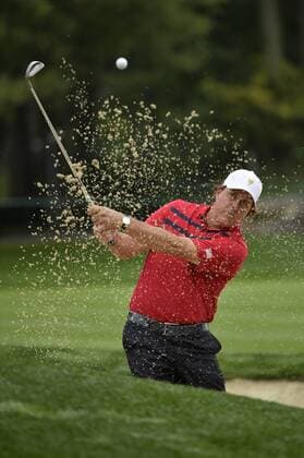 United States Team member Phil Mickelson chips onto the sixth green during the third round four-ball competition against the International Team at the 2013 Presidents Cup at Muirfield Village Golf Club in Dublin, Ohio on October 5, 2013.  BKX2013100513