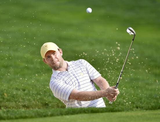International Team member Branden Grace of South Africa chips out of a bunker and onto the seventh green during the third round four-ball competition against the United States Team at the 2013 Presidents Cup at Muirfield Village Golf Club in Dublin, Ohio on October 5, 2013.  BKX2013100530