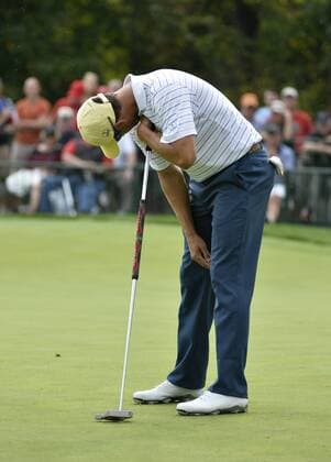 International Team member Adam Scott of Australia reacts after missing a birdie putt on the seventh hole during the third round four-ball competition against the United States Team at the 2013 Presidents Cup at Muirfield Village Golf Club in Dublin, Ohio on October 5, 2013.  BKX2013100541