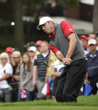 United States Team member Matt Kuchar chips onto the eighth green during the third round four-ball competition against the International Team at the 2013 Presidents Cup at Muirfield Village Golf Club in Dublin, Ohio on October 5, 2013.  BKX2013100548
