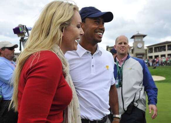 United States Team member Tiger Woods (R) and his girlfriend Lindsey Vonn smile as they stand on the 18th green after the fifth round singles competition at the 2013 Presidents Cup at Muirfield Village Golf Club in Dublin, Ohio on October 6, 2013. The United States defeated the International Team 18.5 to 15.5 to retain the Presidents Cup.  BKX2013100623