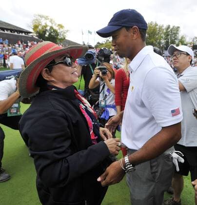 United States Team member Tiger Woods (R) is congratulated by his mother Kultida on the 18th green after the fifth round singles competition at the 2013 Presidents Cup at Muirfield Village Golf Club in Dublin, Ohio on October 6, 2013. The United States defeated the International Team 18.5 to 15.5 to retain the Presidents Cup.  BKX2013100624