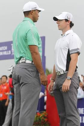 Rory McIlroy of Northern Ireland, right, and Tiger Woods of the United States react during The Match at Mission Hills in Haikou city, south Chinas Hainan province, 28 October 2013. Rory McIlroy finally tasted success for the first time this year when he beat an ailing Tiger Woods by one shot in a megabucks exhibition match in China on Monday (28 October 2013). McIlroy roars against Tiger in China  pau902585_25