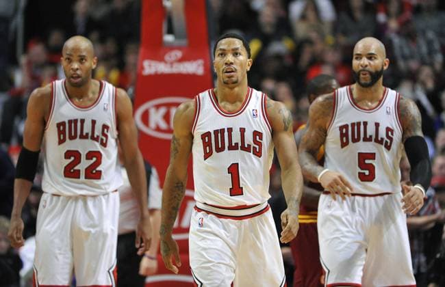 Chicago Bulls Derrick Rose (C) along with teammates Taj Gibson (L) and Carlos Boozer walk up the floor during the fourth quarter against the Cleveland Cavaliers at the United Center in Chicago on November 11, 2013. The Bulls won 96-81.  CHI2013111118