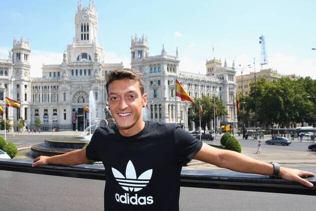 MADRID, SPAIN - AUGUST 28: Mesut Oezil pose in font of the City hall at Plaza de Cibeles during a city tour after the adidas presentation of the new campaign Welcoming Mesut to the family on August 28, 2013 in Madrid, Spain.