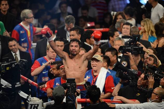 Manny Pacquiao of the Philippines, center top, celebrates after defeating Brandon Rios of the United States in their WBO international welterweight title fight in Macau, China, 24 November 2013. Manny Pacquiao defeat Brandon Rios in WBO international welterweight title fight  20131124_26972