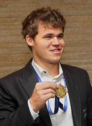 (131125) -- CHENNAI, Nov. 25, 2013 (Xinhua) -- Magnus Carlsen of Norway presents his gold medal after winning the FIDE World Chess Championship 2013 in Chennai, India, Nov. 25, 2013. (Xinhua Stringer) (SP)INDIA-CHENNAI-CHESS-TROPHY 