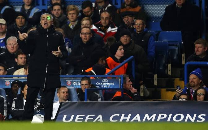 Jose Mourinho, manager of Chelsea, is blinded by a laser pointer during the UEFA Champions League Group E match between Chelsea and FC Steaua Bucharest at Stamford Bridge Stadium in London, Britain, on Dec. 11, 2013. Chelsea won 1-0. (Xinhua Wang Lili) (SP)BRITAIN-LONDON-SOCCER-UEFA CHAMPIONS LEAGUE-GROUP E-CHELSEA VS STEAUA BUCHAREST 