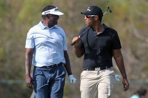 14 DEC 2013: Vijay Singh and his son Qass walk up the fairway during the first round of the PNC Father-Son Challenge at The Ritz-Carlton Golf Club in Orlando, Florida. GOLF: DEC 14 PNC Father-Son Challenge - 1st Round Icon357131214262 EDITORIAL USE ONLY